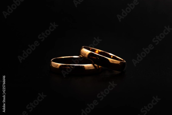 Obraz Wedding rings on a black background close up