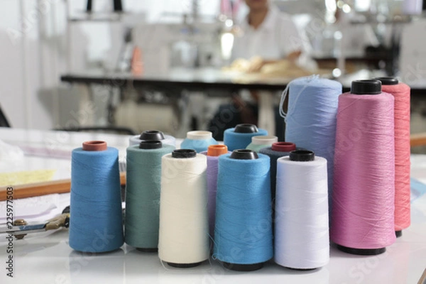 Fototapeta thread in spool on the tailor desk