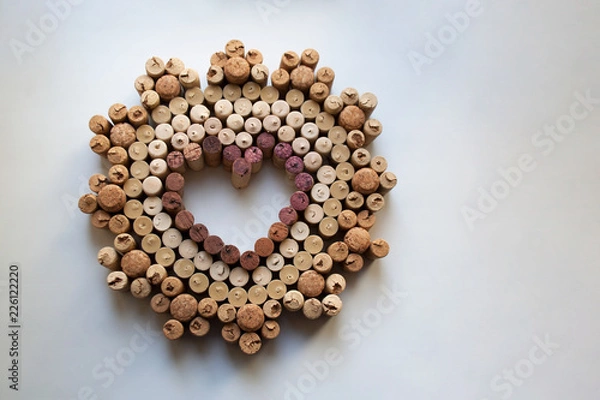 Fototapeta Wine corks heart shaped valentine badge isolated on white background from a high angle view