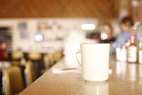 Fototapeta cup of coffee on the counter at a diner