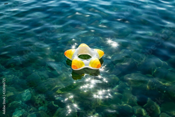 Obraz Little boy with life ring, swimming ring on the transparent water on the center of the picture
