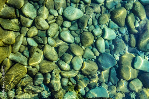 Obraz Pebbles in stream, transparent water as abstract background