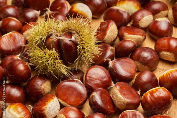 Fototapeta Sweet chestnut on wooden background