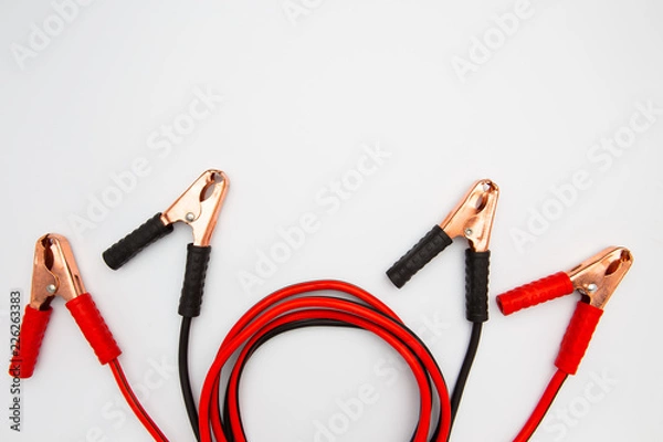 Fototapeta Jump start with crocodile clip or wire red and black clamps for recharge the battery car on a white background. Top view