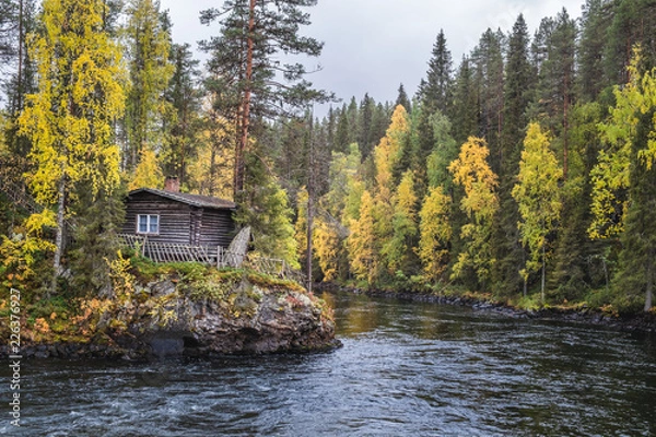 Obraz Beautiful fall colors with cabin and river at autumn day in Myllykoski, Kuusamo, Finland