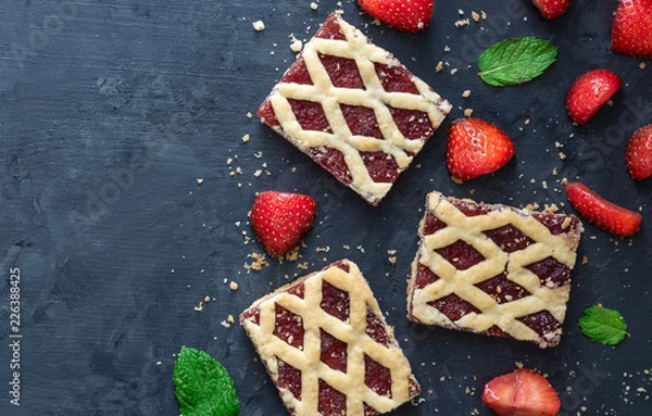 Fototapeta Strawberry cookies with strawberry fruits on dark background.