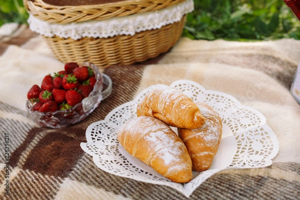 Obraz Picnic on grass with small croissants, strawberries