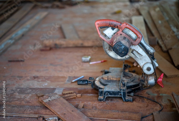 Fototapeta Man doing woodwork in carpentry. Carpenter work on wood plank in workshop