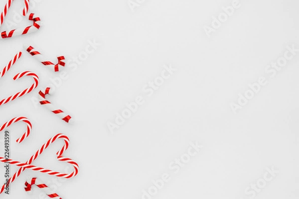 Fototapeta Christmas composition. Christmas frame made of candy cane on white background. Creative flat lay, top view design
