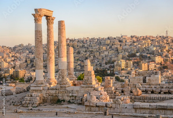 Obraz Amman, Jordan its Roman ruins in the middle of the ancient citadel park in the center of the city. Sunset on Skyline of Amman and old town of the city with nice view over historic capital of Jordan.