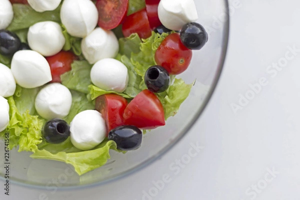 Fototapeta Vegetable salad with cherry tomato, olives and mozarella