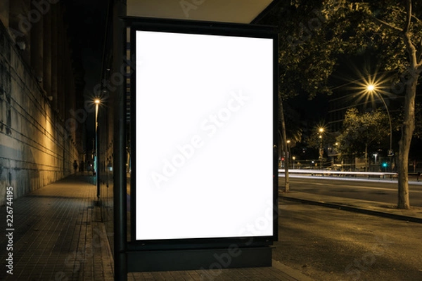 Fototapeta Light box display at bus stop in night city. White blank space for ads. Marketing concept. Horizontal mock-up.
