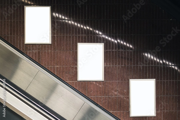 Fototapeta Three white blank spaces for advertisement on wall. Subway mock-up design. Horizontal