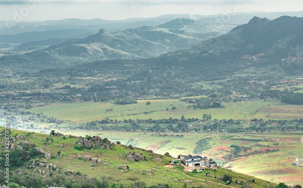 Obraz Ezulwini valley in Swaziland with beautiful mountains, trees and rocks in scenic green valley between Mbabane and Manzini cities. Traditional huts houses of Swaziland