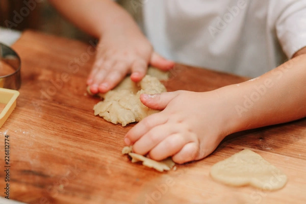 Obraz Child mixing flour in the kitchen, making dough