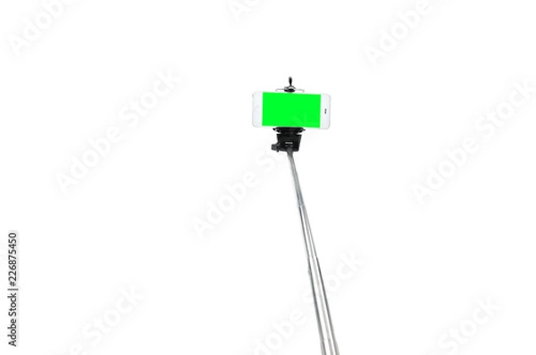 Fototapeta Selfie stick and smartphone on an isolated white background