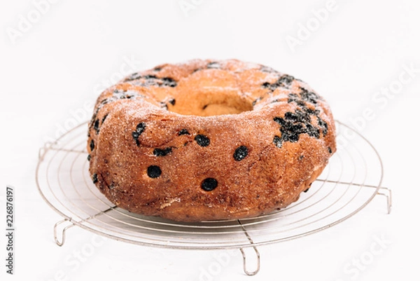 Fototapeta Traditional German or Austrian Gugelhupf or Kouglof from Alsace, France, a round bundt cake with raisins made of brioche yeast sponge or sweet bread dough and dusted with sugar