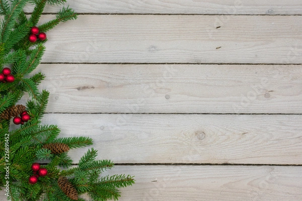 Obraz Holiday border with greenery along the left side with copy space