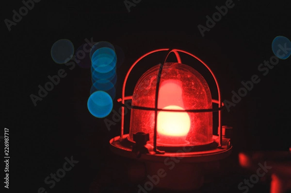 Obraz red lamp on black background