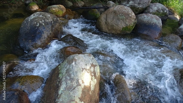 Obraz water flowing over rocks