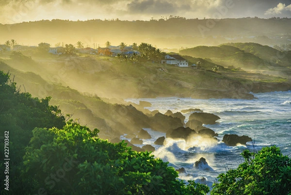 Obraz Water spray hitting the land after strong waves splash on the rock, sunset at Ragged point in Eastern-Barbados