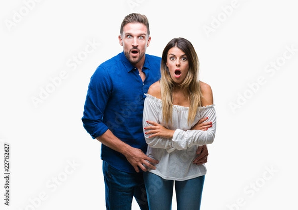 Fototapeta Young couple in love over isolated background afraid and shocked with surprise expression, fear and excited face.