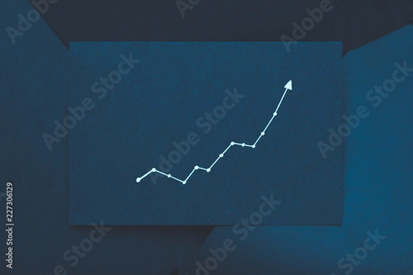 Obraz exponential graph. growth improvement progress concept. arrow pointing upward on teal blue paper.
