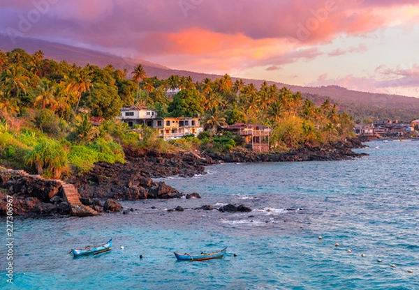 Obraz Sunset boats in holiday paradise resort on Grand Comore island, Comoros. Beautiful sunset light of sun in the sea. Villas on the beach with private beach. Moroni Comoros, Itsandra beach resort hotel