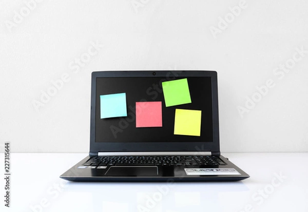 Obraz Laptop on desks with Sticky Notes  In the office of a businessman
