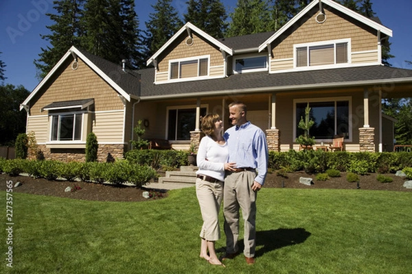 Obraz senior couple in front of their house