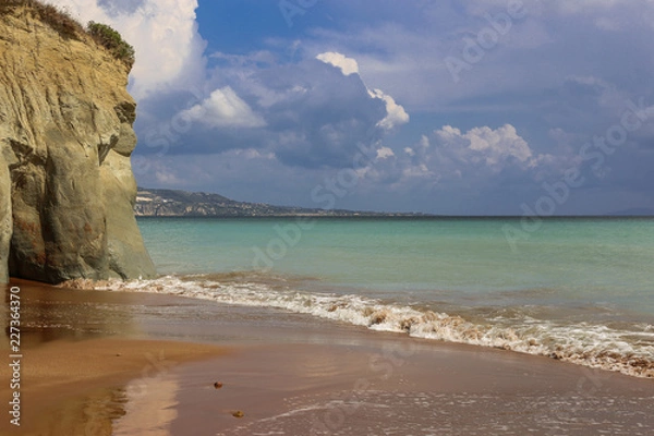 Fototapeta Sea view and cloudy sky before the storm. Photo taken on the famous Xi beach with red sand and clay stone on the Ionian island of Kefalonia, Greece