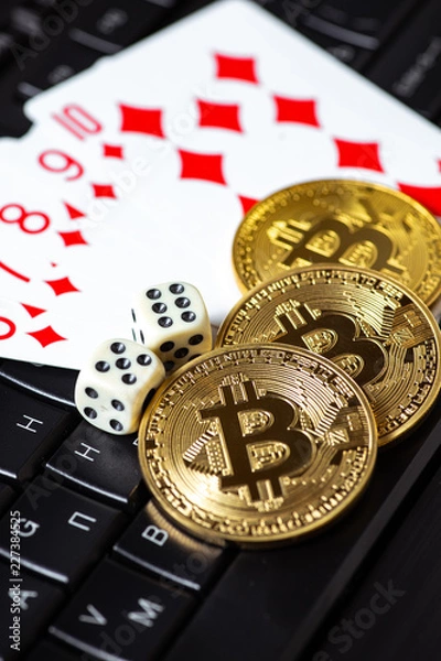 Fototapeta Bitcoins, cards and dices on keyboard. Cryptocurrencie gambling concept