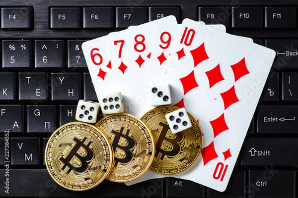 Fototapeta Bitcoins, cards and dices on keyboard. Cryptocurrencie gambling concept