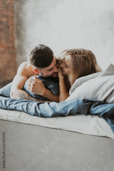 Obraz 
beautiful loving couple kissing in bed