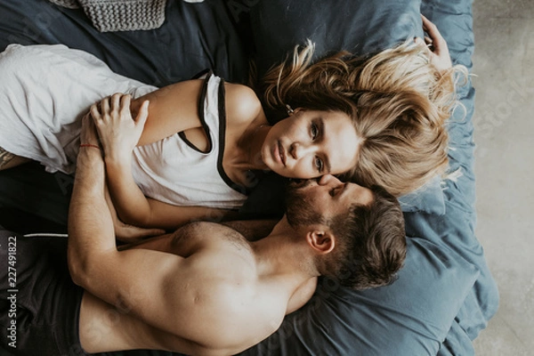 Obraz 
Beautiful loving couple kissing in bed