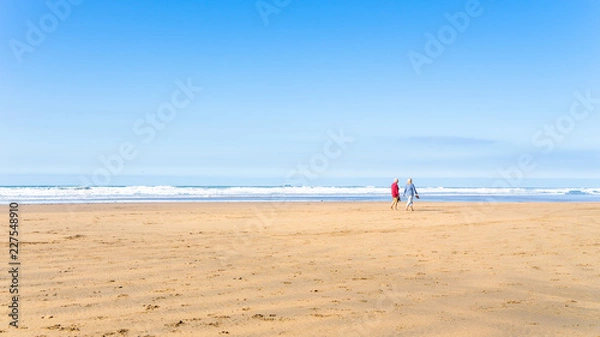 Obraz A couple taking a walk along a Cornwall Bude beach
