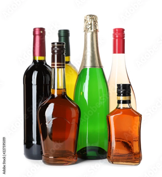 Fototapeta Bottles with different alcoholic drinks on white background