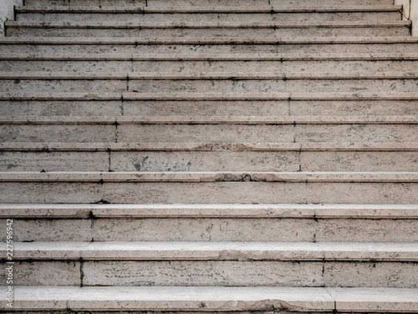 Fototapeta Abstract background of marble stairway. Step of rock stair with vintage style. Grunge texture of outdoor staircase. Low angle view step of stairs. Aged and broken in some step.