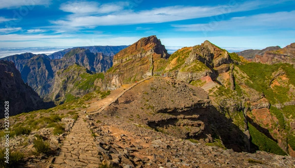 Obraz Madeira, Portugal. Tourists on a hiking path between Pico do Arieiro and Pico do Ruivo above the clouds.