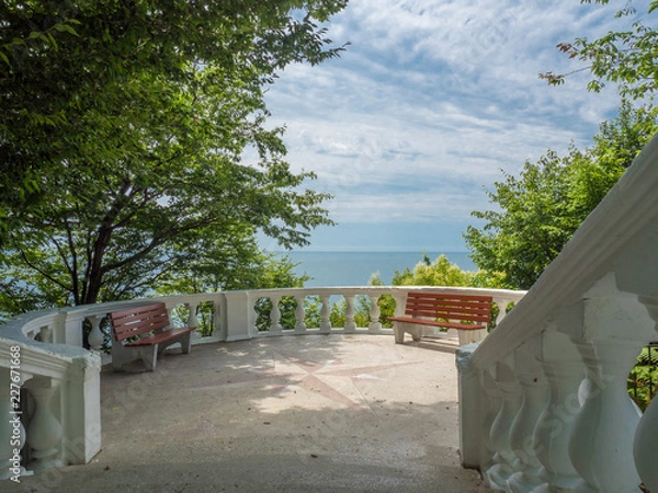Fototapeta Observation deck with stairs and sea views located in the forest