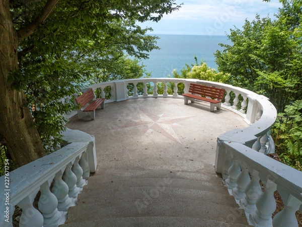 Fototapeta Observation deck with stairs and sea views located in the forest