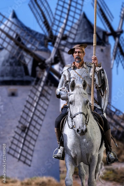 Fototapeta Don Quixote on horseback, with the windmills behind