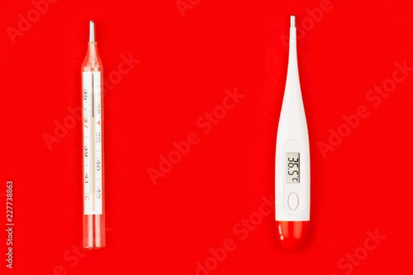 Fototapeta Danger glass human body mercury thermometers compare to safety electric body thermometers on red background. Environment care / issue, recycling / reuse, safe planet, ecology concept.