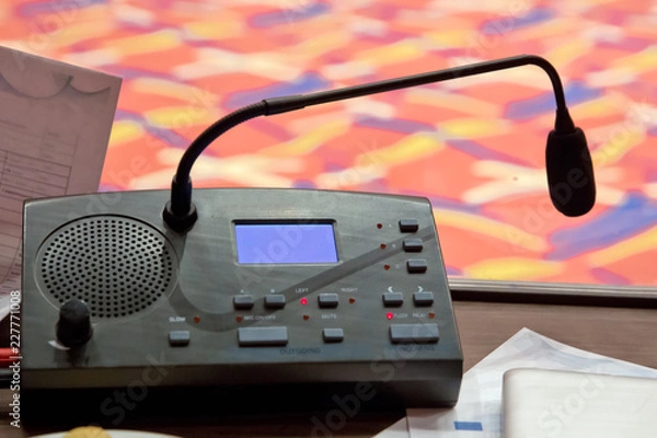 Fototapeta Translator room . translators cubicle . interpreting - Microphone and switchboard in an simultaneous interpreter booth . Soft focus of wireless Conference microphones and notebook in a meeting room.