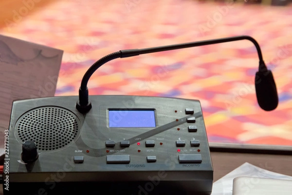 Fototapeta Translator room . translators cubicle . interpreting - Microphone and switchboard in an simultaneous interpreter booth . Soft focus of wireless Conference microphones and notebook in a meeting room.