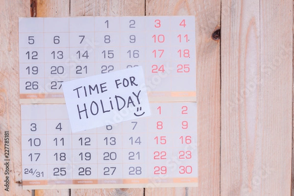 Fototapeta Time For Holiday written on paper note on a wall calendar with wooden background and copy space