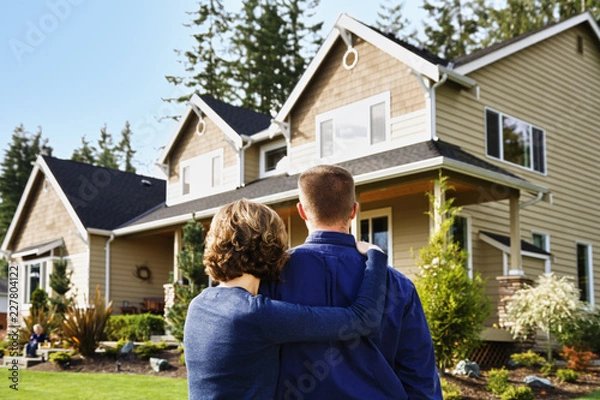 Obraz happy couple in front of new house
