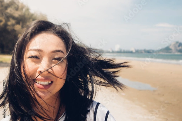 Obraz Happy and playful woman walking on the beach.