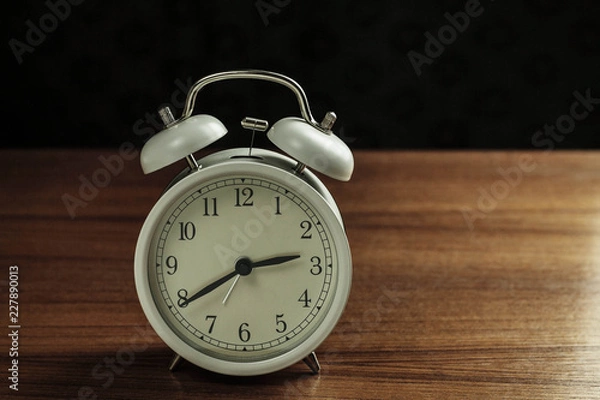 Fototapeta alarm clock with black background.