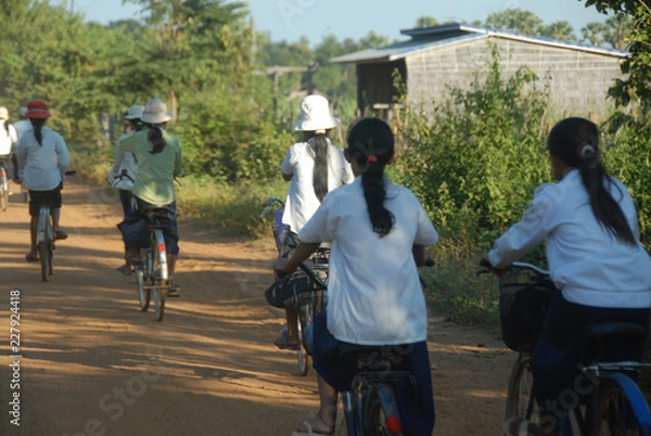 Obraz Students riding bicycles to school